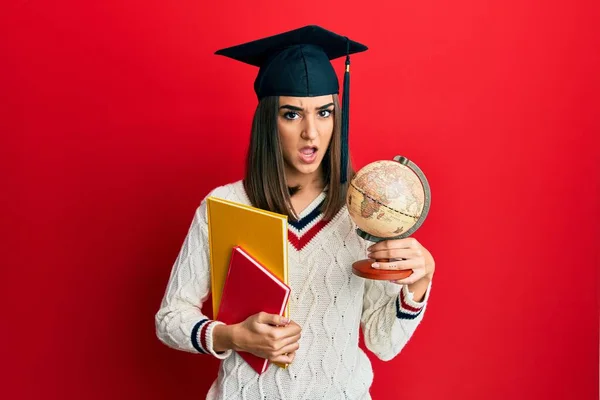 Ung Brunett Flicka Tog Examen Geografi Chock Ansikte Ser Skeptisk — Stockfoto