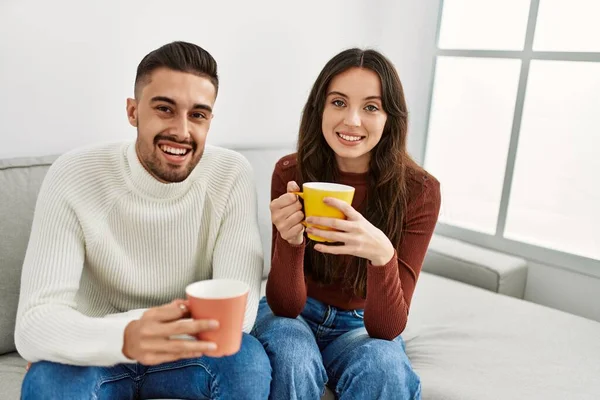 Jovem Casal Hispânico Bebendo Café Sentado Sofá Casa — Fotografia de Stock