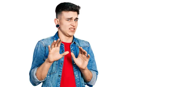 Young Caucasian Boy Ears Dilation Wearing Casual Denim Jacket Disgusted — Stock Photo, Image