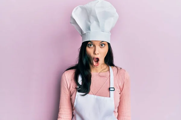 Young Hispanic Woman Wearing Baker Uniform Cook Hat Scared Amazed — Stock Photo, Image