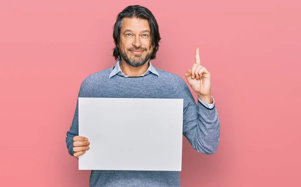 Middle Age Handsome Man Holding Blank Empty Banner Surprised Idea — Stock Photo, Image