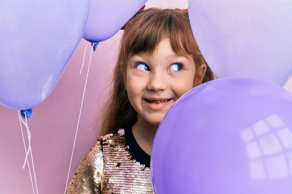 Little Caucasian Girl Kid Holding Balloons Smiling Looking Side Staring — Stock Photo, Image