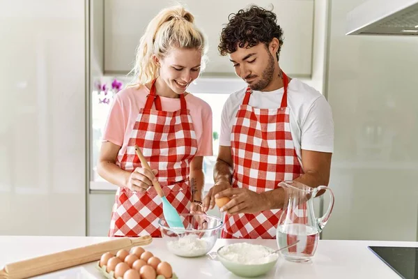 Pareja Joven Sonriendo Feliz Mezclando Ingredientes Para Hacer Masa Para —  Fotos de Stock