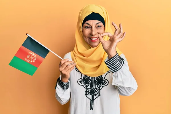 Middle Age Hispanic Woman Holding Afghanistan Flag Doing Sign Fingers — Stock Photo, Image