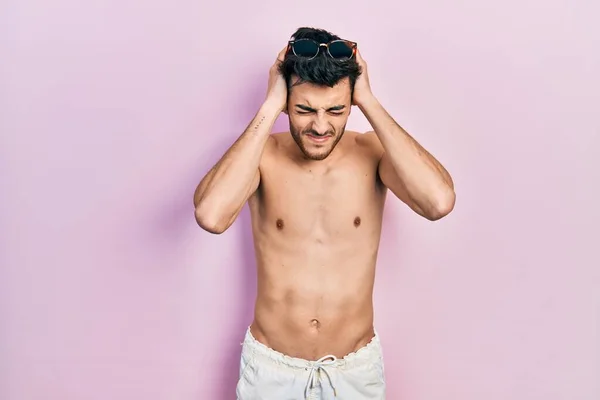 Young Hispanic Man Wearing Swimwear Shirtless Suffering Headache Desperate Stressed — Stock Photo, Image