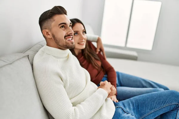 Young Hispanic Couple Hugging Resting Sofa Home — Stock Photo, Image