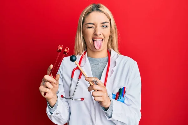 Young Caucasian Woman Wearing Doctor Uniform Holding Tuning Fork Sticking — Stock Photo, Image