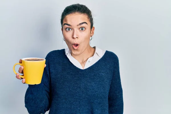 Young Caucasian Girl Holding Coffee Scared Amazed Open Mouth Surprise — Stock Photo, Image