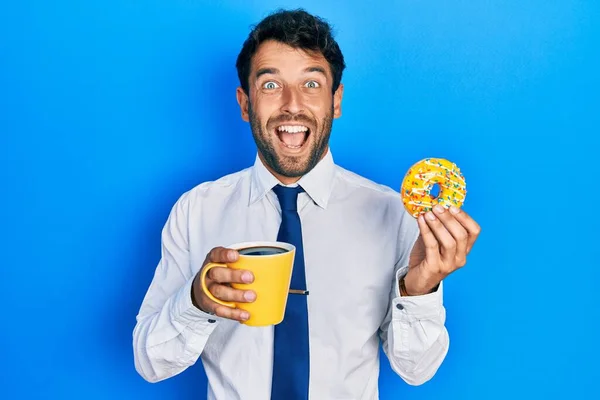 Handsome Business Man Beard Eating Doughnut Drinking Coffee Celebrating Crazy — Stock Photo, Image