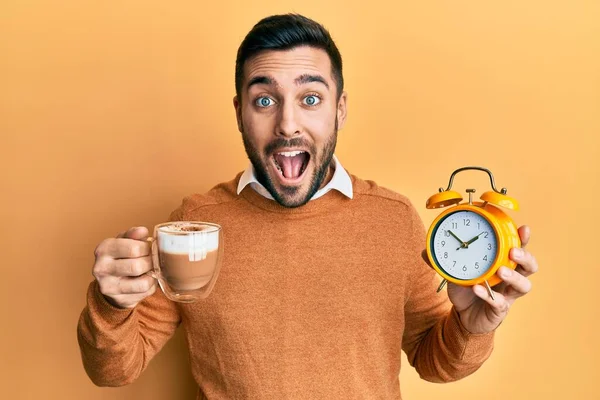 Junger Hispanischer Mann Hält Kaffee Und Wecker Der Hand Und — Stockfoto