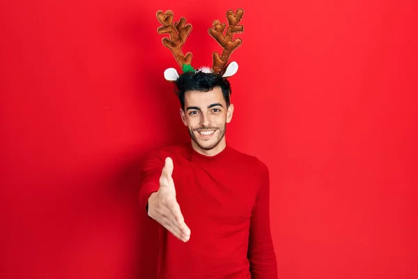 Young Hispanic Man Wearing Cute Christmas Reindeer Horns Smiling Friendly — Stock Photo, Image