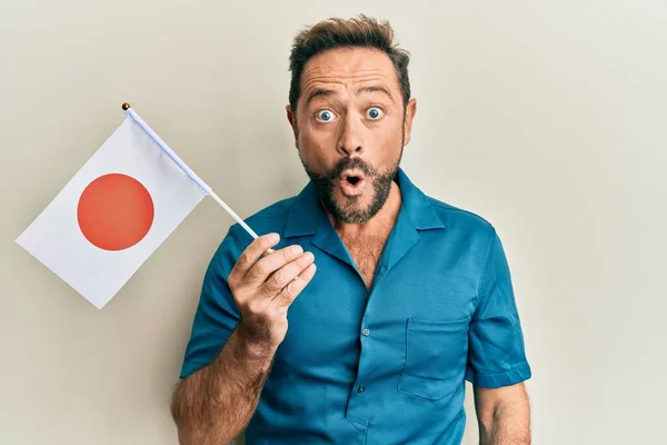 Homem Meia Idade Segurando Bandeira Japão Assustado Espantado Com Boca — Fotografia de Stock