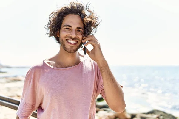 Joven Hombre Hispano Sonriendo Feliz Hablando Smartphone Pie Playa — Foto de Stock