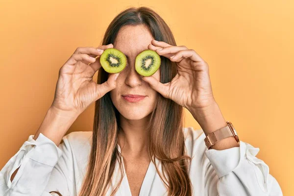 Young Beautiful Woman Holding Slice Kiwi Eyes Relaxed Serious Expression — Stock Photo, Image