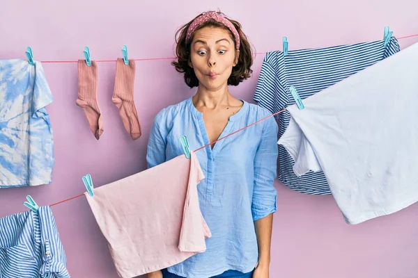 Young Brunette Woman Doing Laundry String Hangs Making Fish Face — Stock Photo, Image