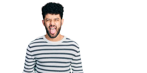 Young Arab Man Beard Wearing Casual Striped Sweater Sticking Tongue — Stock Photo, Image