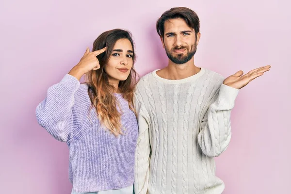 Young Hispanic Couple Wearing Casual Clothes Confused Annoyed Open Palm — ストック写真