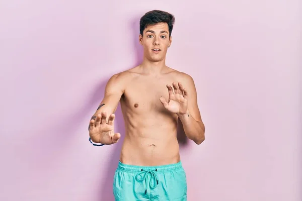 Young Hispanic Man Wearing Swimwear Shirtless Afraid Terrified Fear Expression — Stock Photo, Image
