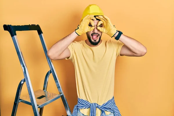 Handsome Man Beard Construction Stairs Wearing Hardhat Doing Gesture Binoculars — Stock Photo, Image
