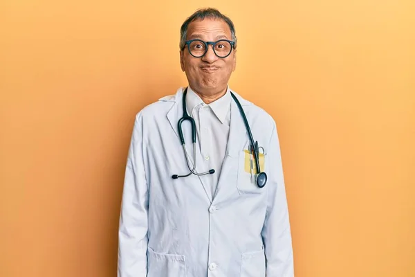 Middle Age Indian Man Wearing Doctor Coat Stethoscope Puffing Cheeks — Stock Photo, Image