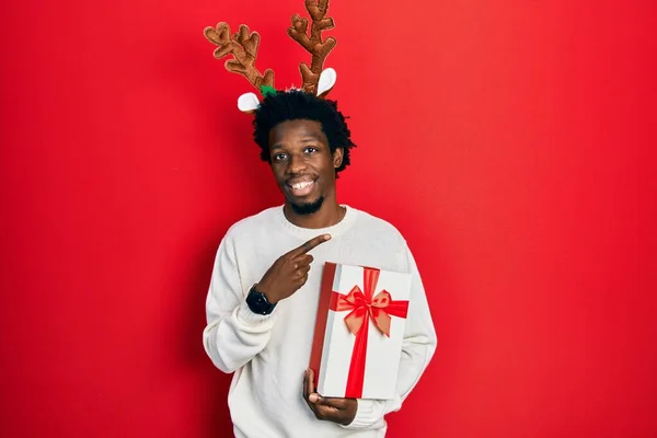 Jovem Afro Americano Vestindo Chapéu Natal Veado Segurando Presente Alegre — Fotografia de Stock
