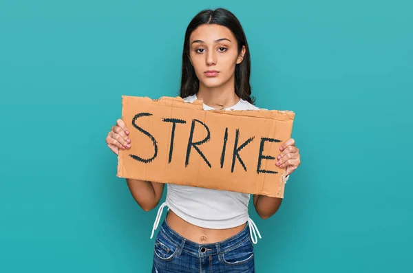 Young Hispanic Girl Holding Strike Banner Cardboard Thinking Attitude Sober — Stock Photo, Image