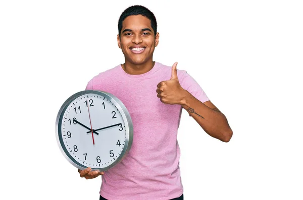 Young Handsome Hispanic Man Holding Big Clock Smiling Happy Positive — Stock Photo, Image