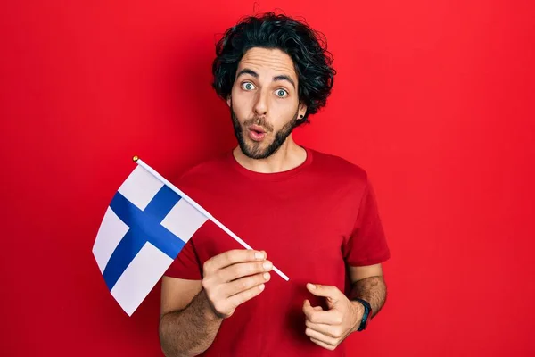 Knappe Spaanse Man Die Vlag Van Finland Vasthoudt Bang Verbaasd — Stockfoto