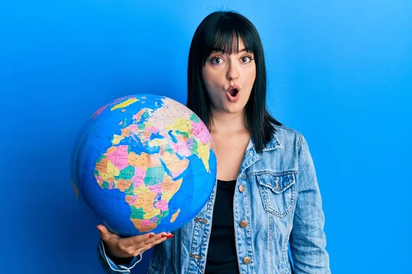 Young Hispanic Woman Holding World Ball Scared Amazed Open Mouth — Stock Photo, Image