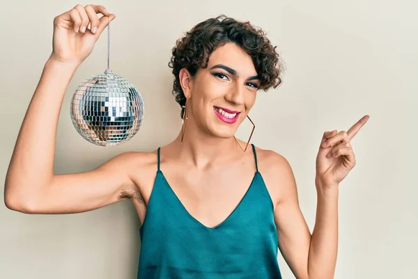 Young Hispanic Gay Holding Shiny Disco Ball Smiling Happy Pointing — Stock Photo, Image