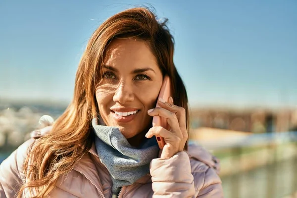 stock image Young hispanic woman smiling happy talking on the smartphone at the city.