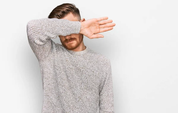 Young Redhead Man Wearing Casual Winter Sweater Covering Eyes Arm —  Fotos de Stock