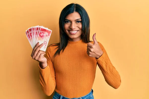 Young Latin Transsexual Transgender Woman Holding Israel Shekels Banknotes Smiling — Stock fotografie