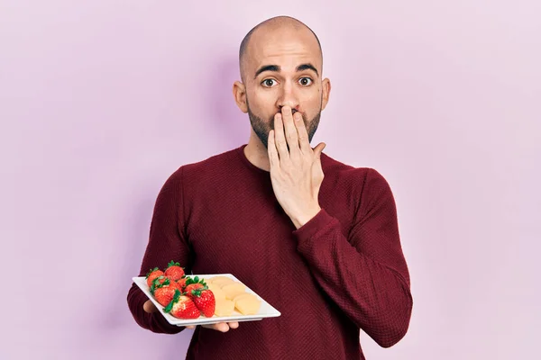 Young Bald Man Eating Fresh Healthy Fruits Covering Mouth Hand — Φωτογραφία Αρχείου