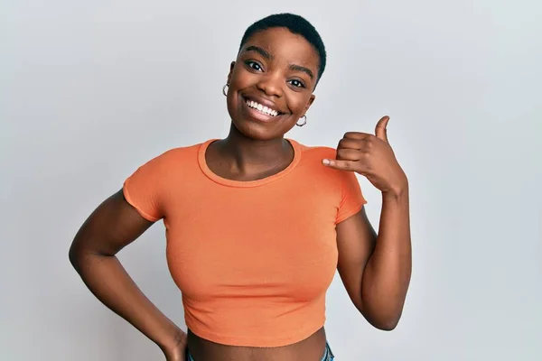Genç Afro Amerikalı Kadın Günlük Turuncu Tişört Giyip Gülümsüyor Telefonla — Stok fotoğraf