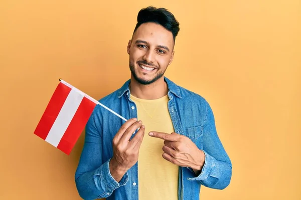 Young Arab Man Holding Austria Flag Smiling Happy Pointing Hand — Stockfoto