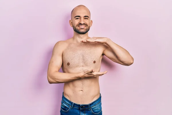 Young Bald Man Standing Shirtless Gesturing Hands Showing Big Large — Foto de Stock