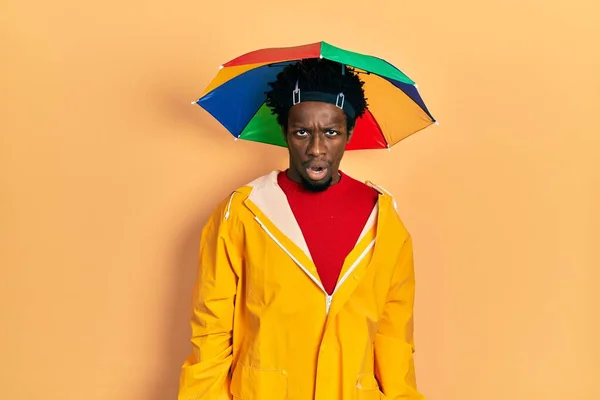 Young African American Man Wearing Yellow Raincoat Shock Face Looking — Stock Photo, Image