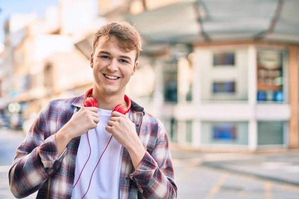 若い白人男性笑顔幸せな使用ヘッドフォンで市内 — ストック写真