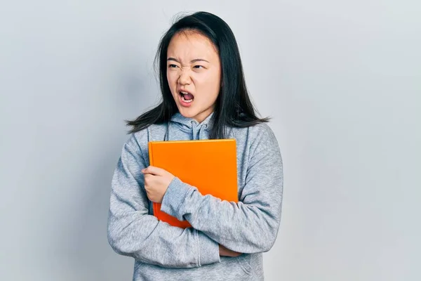 Joven Chica China Sosteniendo Libro Enojado Loco Gritando Frustrado Furioso —  Fotos de Stock