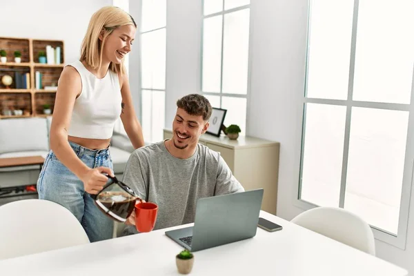 Man Working Using Laptop Home His Girlfriend Pouring Coffee — Stock Photo, Image