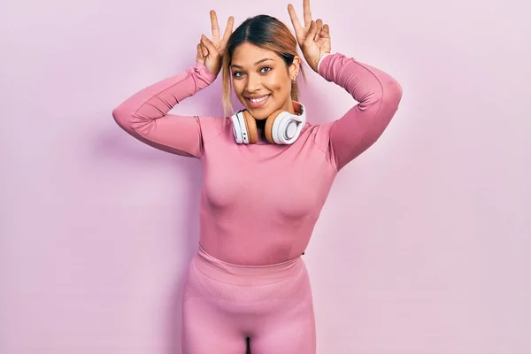 Beautiful Hispanic Woman Wearing Gym Clothes Using Headphones Posing Funny — 스톡 사진