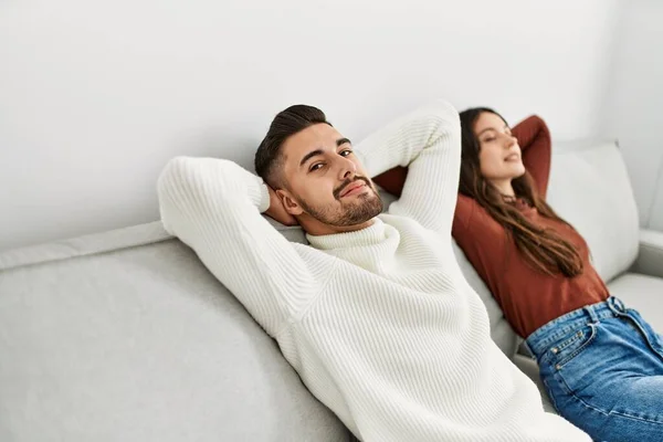 Young Hispanic Couple Resting Head Hands Sitting Sofa Home — Stock Photo, Image