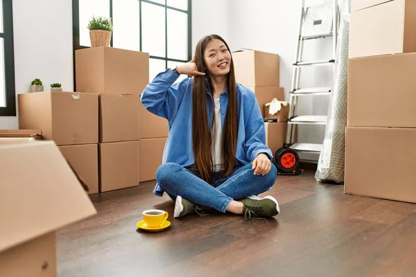 Yeni Evinde Yerde Oturmuş Gülümseyen Genç Çinli Kız Telefonla Parmaklarıyla — Stok fotoğraf