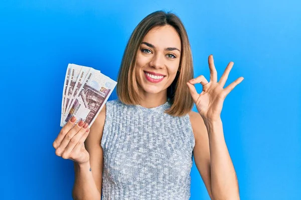 Young Caucasian Blonde Woman Holding Egyptian Pounds Banknotes Doing Sign — Stock Photo, Image