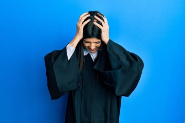 Genç İspanyol kadın yargıç üniforması giyiyor. Baş ağrısı, acı ve migren yüzünden çaresiz ve stresli. Eller başının üstünde.. 