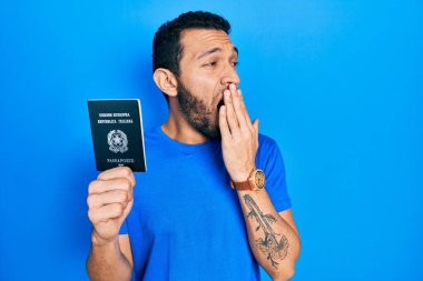 İtalyan pasaportlu İspanyol sakallı adam ağzını eliyle kapatmaktan sıkılmış. Huzursuz ve uykulu.. 