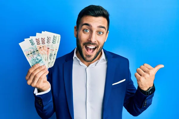 Young Hispanic Businessman Wearing Business Suit Holding Czech Koruna Banknotes — Stock Photo, Image