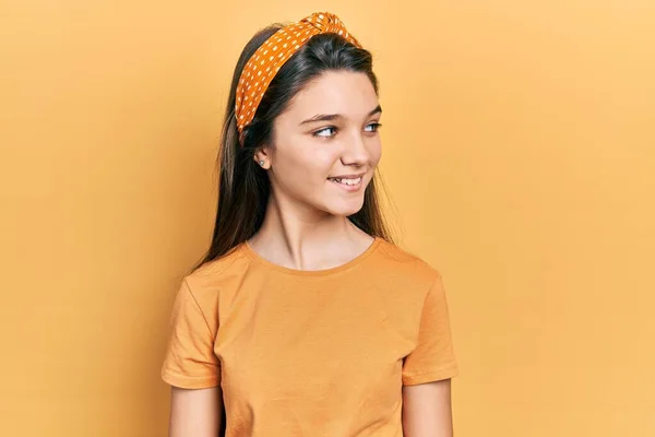 Young Brunette Girl Wearing Casual Orange Shirt Looking Away Side — Stock Photo, Image