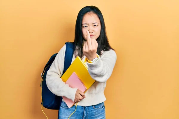 Young Chinese Girl Holding Student Backpack Books Showing Middle Finger — Fotografia de Stock